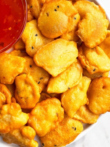 Easy One Pot Crispy Potato Fritters in White Dish (Indian Aloo Pakora)- Overhead Shot.