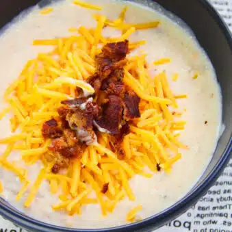 Easy Instant Pot Potato Soup With Bacon and Cheddar Cheese in Black Bowl on Newspaper