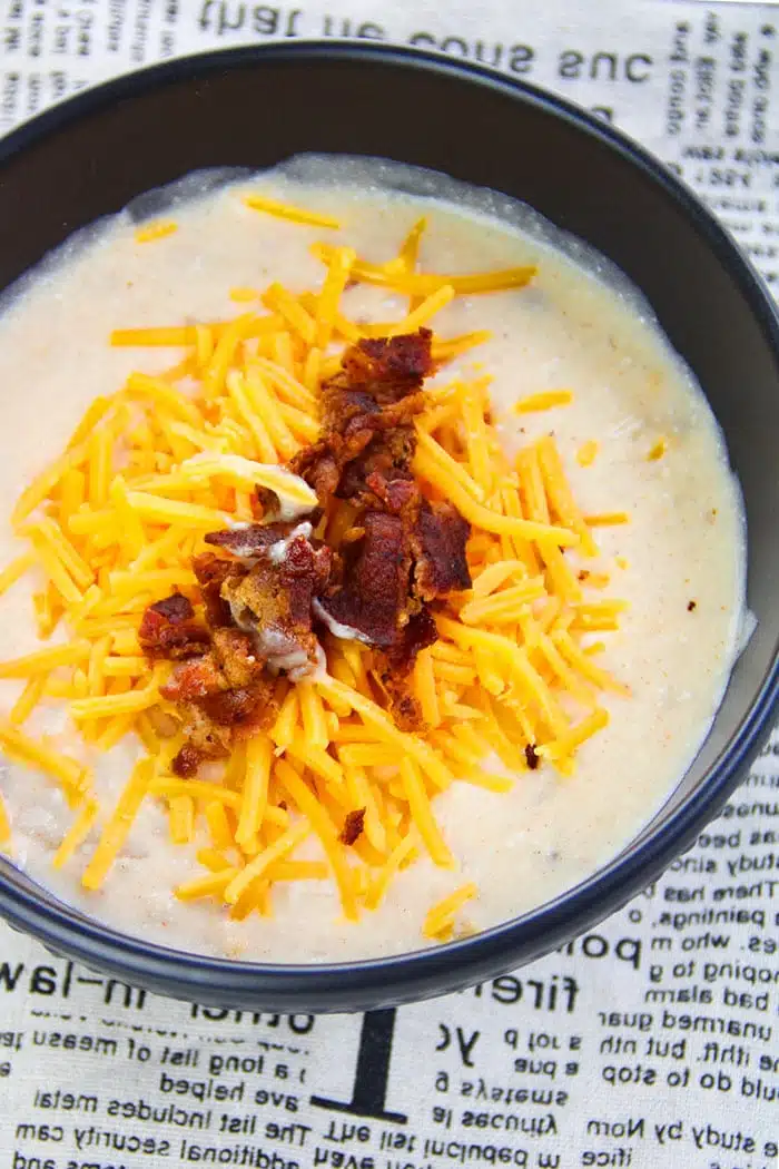 Pressure Cooker Loaded Potato Soup in Black Bowl on Newspaper