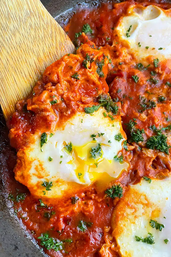 Egg Yolk Oozing in Mediterranean Tomato Sauce- Closeup Shot