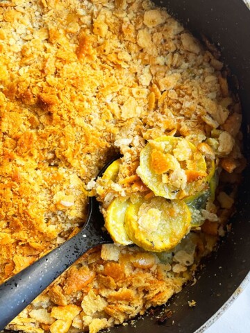 Easy Yellow Squash Casserole With Crispy Ritz Cracker Topping in Black Pot