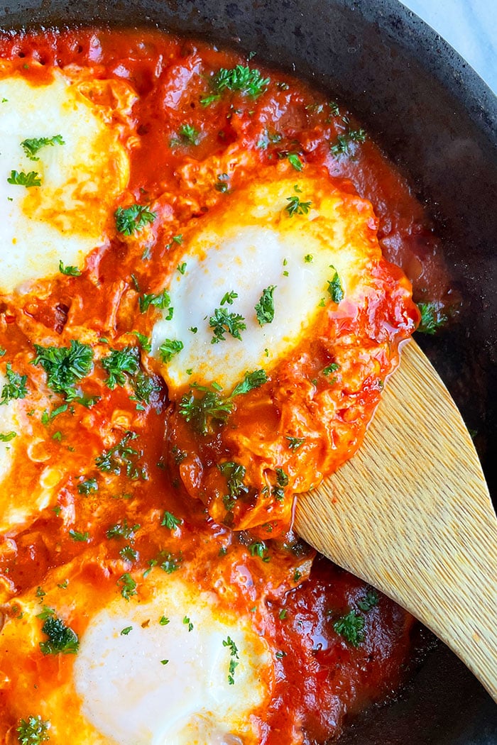 Spoonful of Poached Eggs in Mediterranean Tomato Sauce