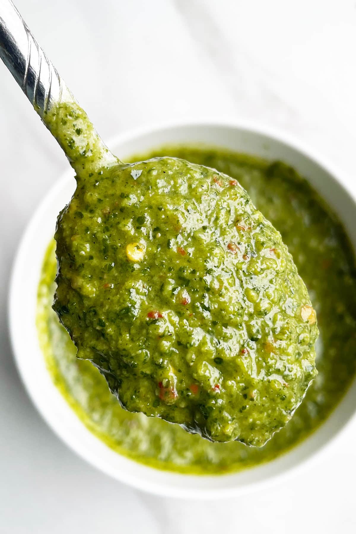 Spoonful of Green Spicy Cilantro Sauce Over Marble Background- Closeup Shot.
