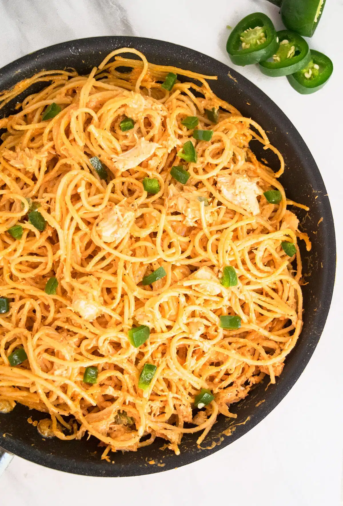 Easy Creamy Buffalo Chicken Pasta on Marble Background. 