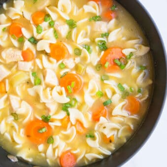 Easy Homemade Chicken Noodle Soup in Black Nonstick Pot.
