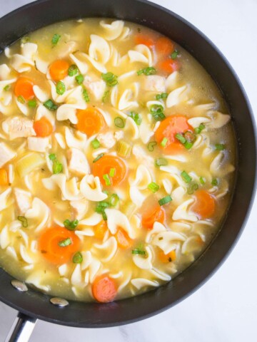 Easy Homemade Chicken Noodle Soup in Black Nonstick Pot.