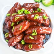 Easy One Pot Grape Jelly Little Smokies Appetizer Served in White Dish.