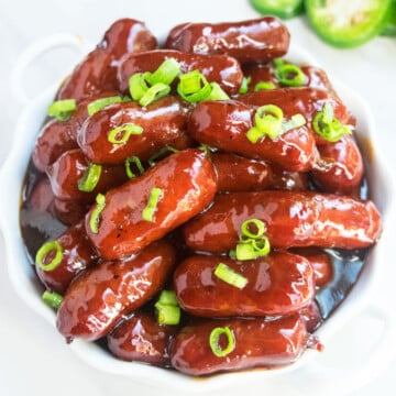 Easy One Pot Grape Jelly Little Smokies Appetizer Served in White Dish.