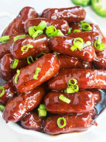 Easy One Pot Grape Jelly Little Smokies Appetizer Served in White Dish.