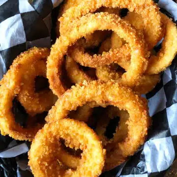 Easy One Pot Crispy Fried Onion Rings in Lined Basket.