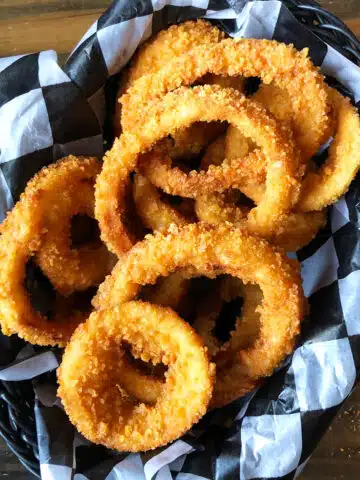 Easy One Pot Crispy Fried Onion Rings in Lined Basket.