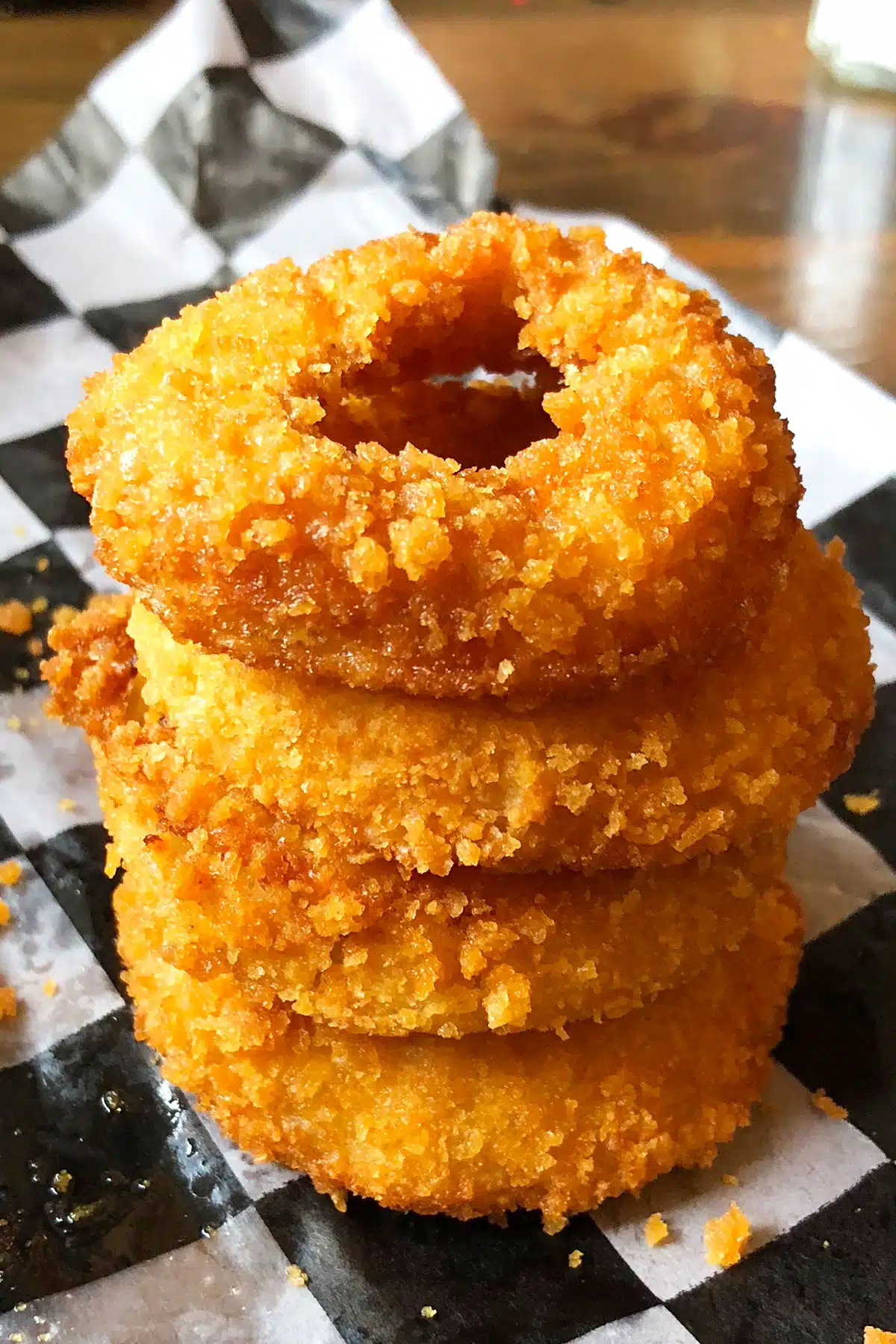 Stack or Tower of Fried Onions on Black and White Sheet of Parchment Paper. 