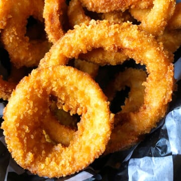 Easy One Pot Crispy Fried Onion Rings in Lined Basket.
