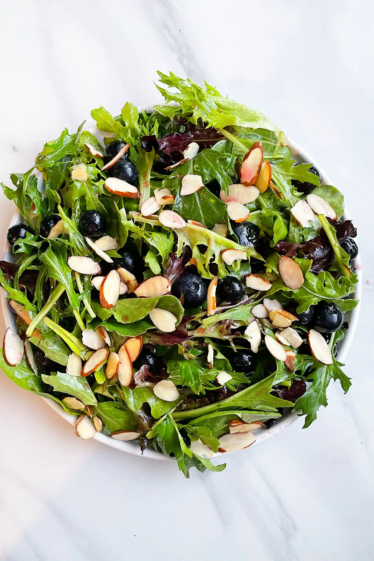 White Dish Full of Easy Blueberry Salad With Blueberry Vinaigrette.
