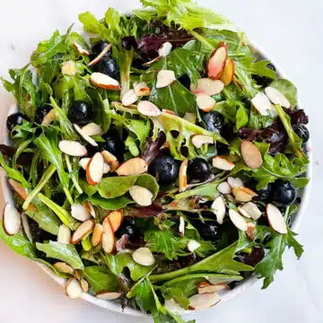 White Dish Full of Easy Blueberry Salad With Blueberry Vinaigrette.