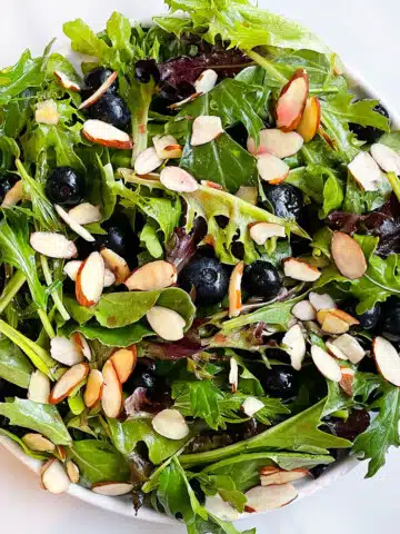 White Dish Full of Easy Blueberry Salad With Blueberry Vinaigrette.