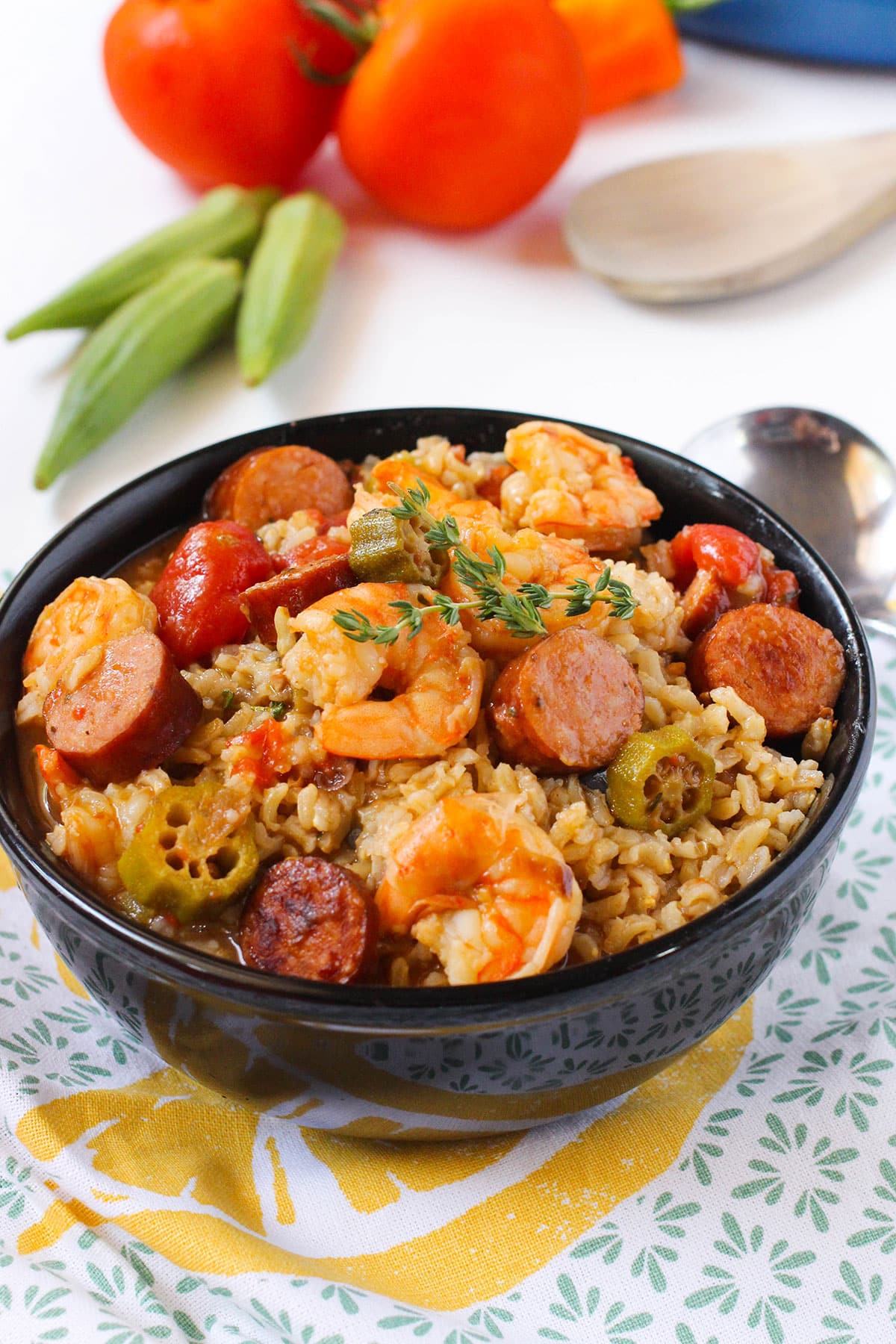 Bowl of Easy One Pot Creole Gumbo With Sausage and Shrimp Over Rice in Black Bowl. 
