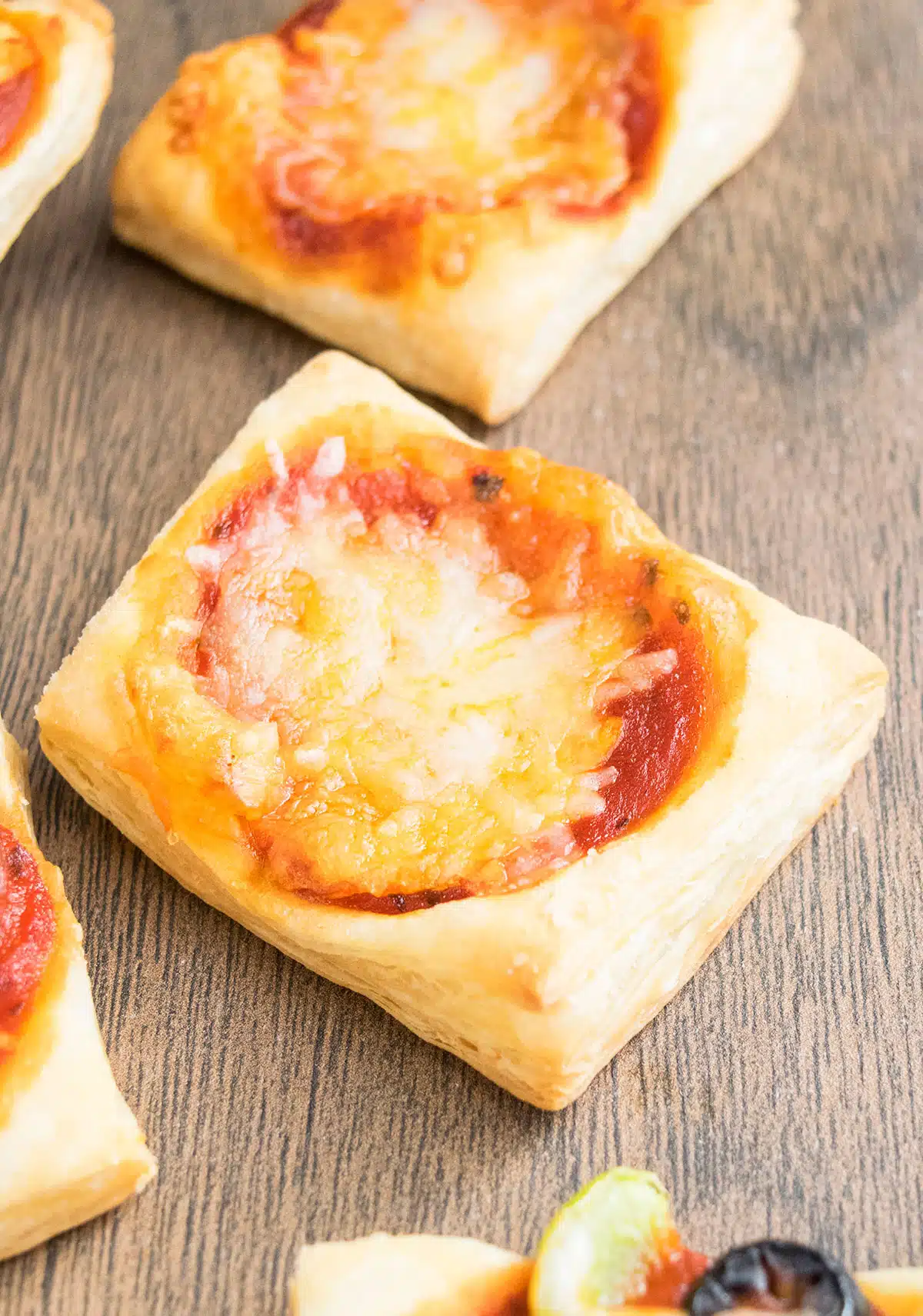 Mini pizza appetizer on wood background. 