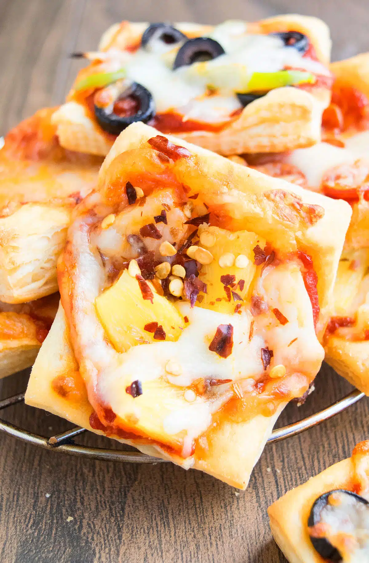 Closeup shot of pineapple, cheese and red chili flake toppings. 