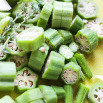 Sliced okra on cutting board. 