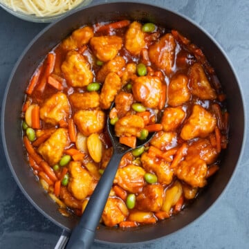 Overhead shot of best easy homemade Chinese sweet and sour chicken in nonstick pot- Overhead shot.