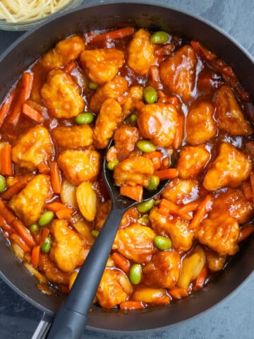 Overhead shot of best easy homemade Chinese sweet and sour chicken in nonstick pot- Overhead shot.