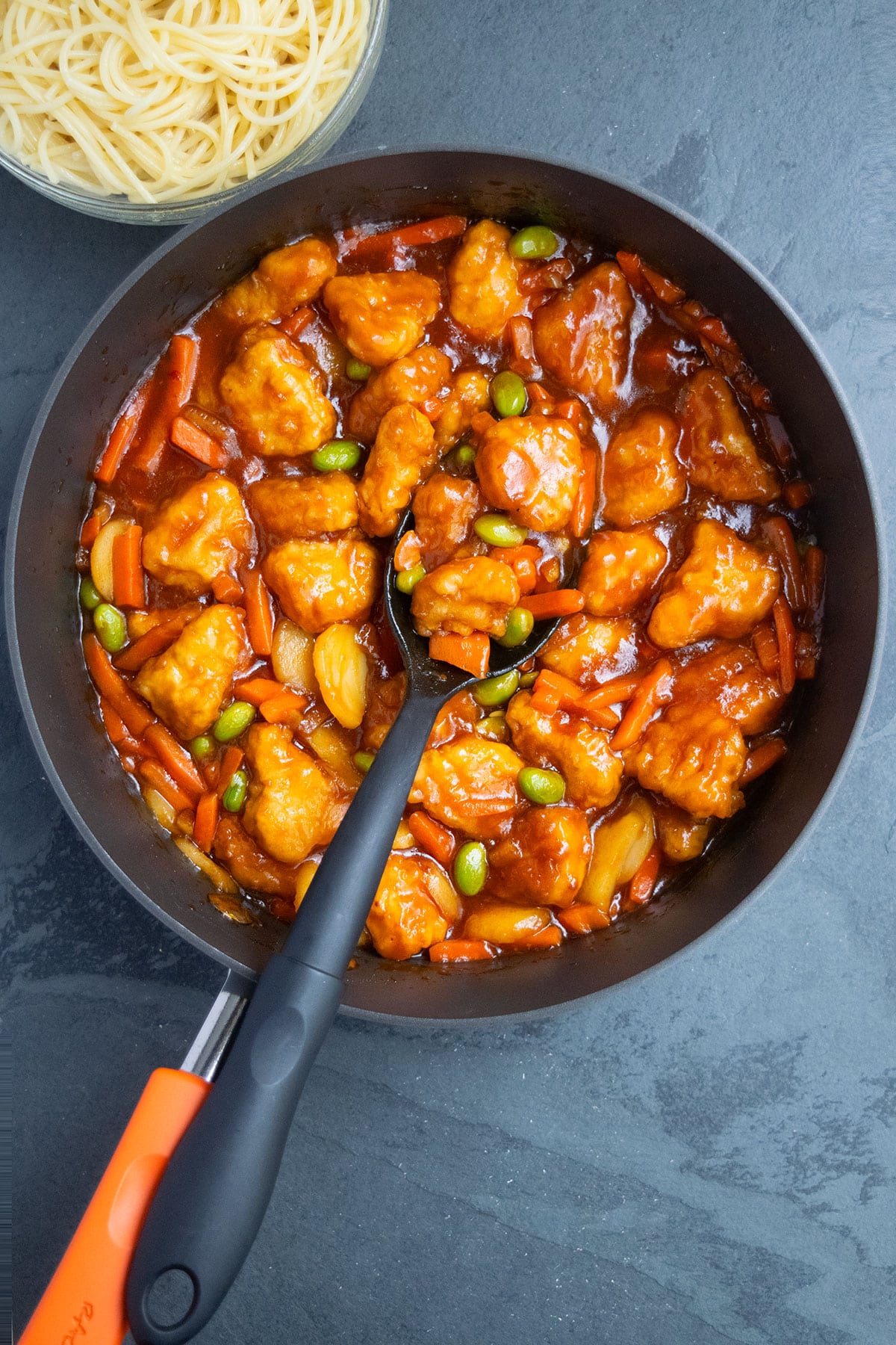 Easy homemade Chinese sweet and sour chicken in nonstick pan- Overhead shot. 