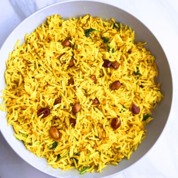 Best easy one pot spicy rice (peanut rice) served in off white bowl on marble background.