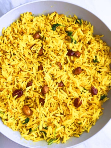Best easy one pot spicy rice (peanut rice) served in off white bowl on marble background.