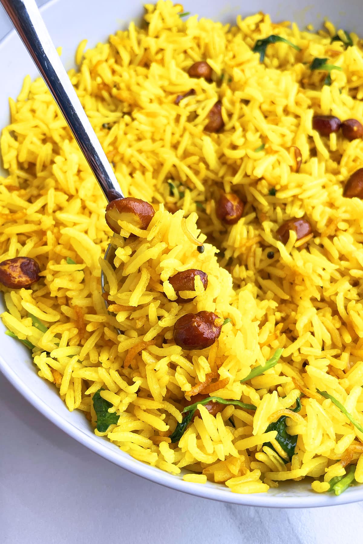 Spoonful of yellow peanut rice- Closeup shot. 