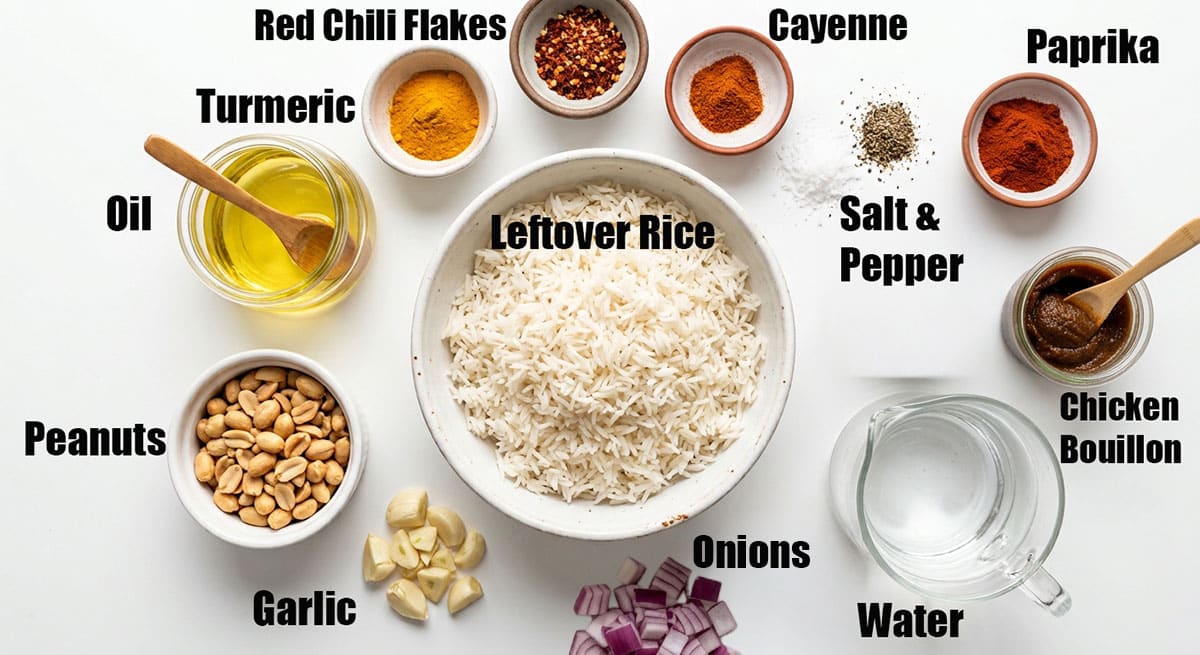 Ingredients for recipe on white background- spices, boiled rice, chicken bouillon, oil, garlic, onion, water, peanuts.  