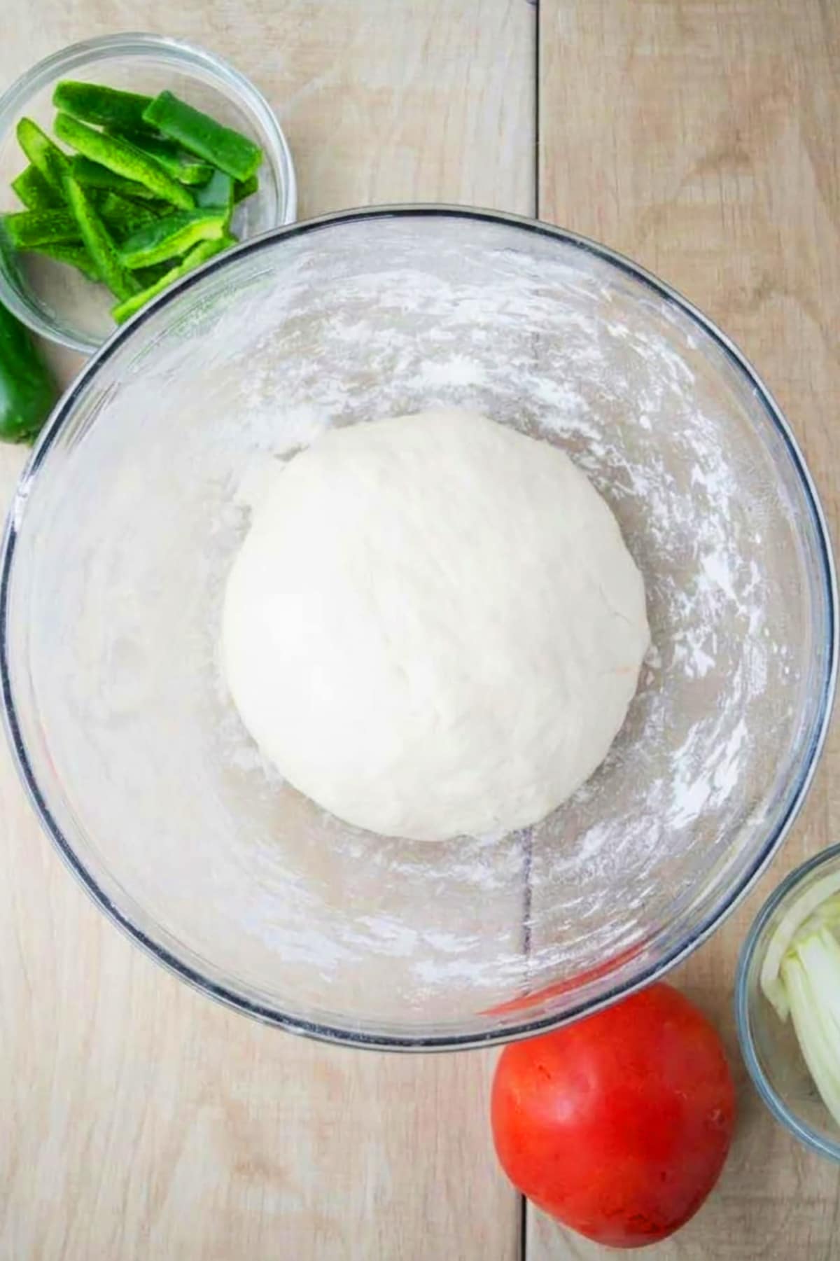 Ball of dough in a glass bowl- Overhead shot. 