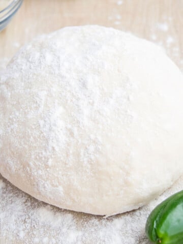 Easy 2 ingredient yogurt pizza dough on wooden tabletop.