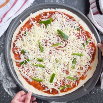 Overhead shot of unbaked pizza with toppings about to be baked. 